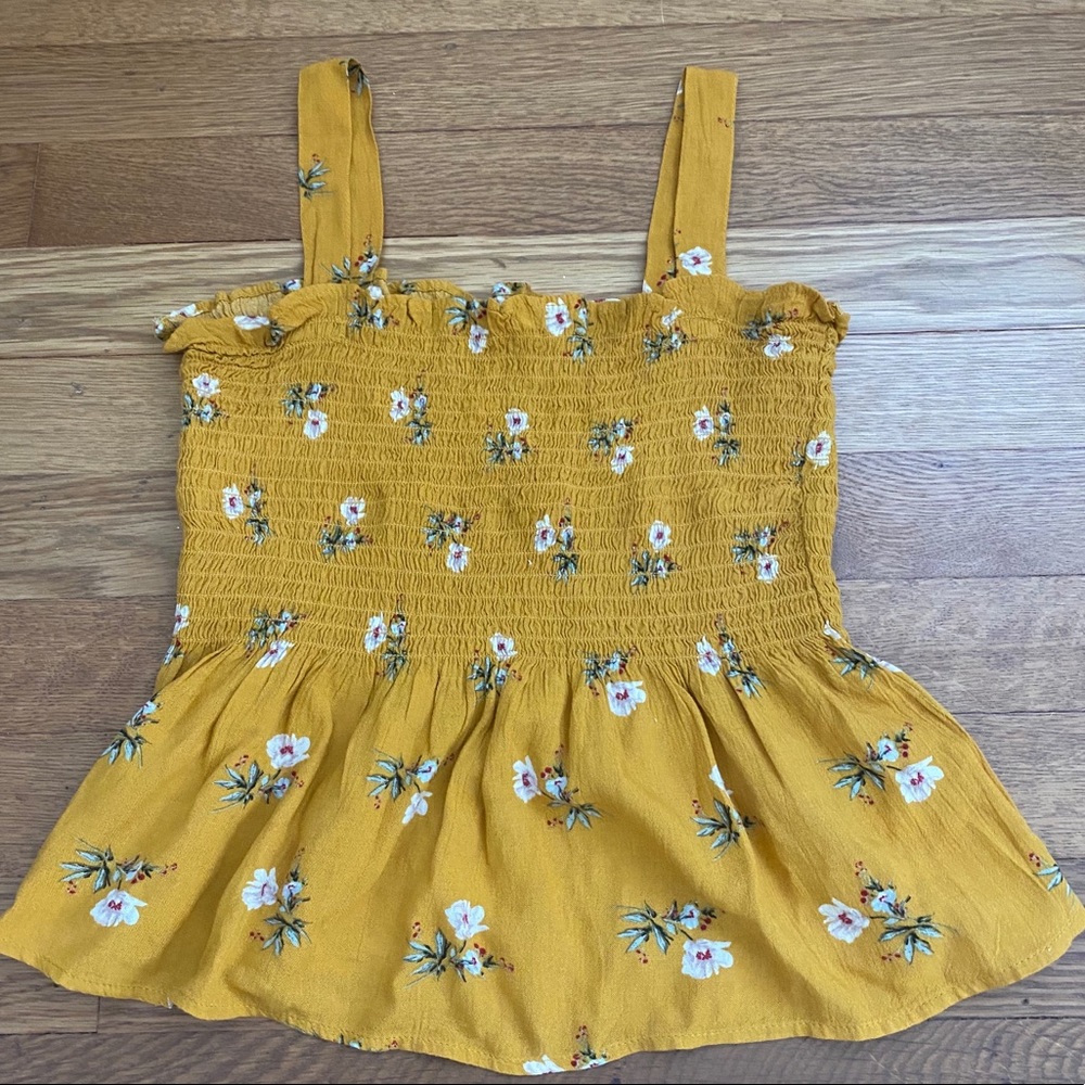 yellow American eagle tank top with a flower on it